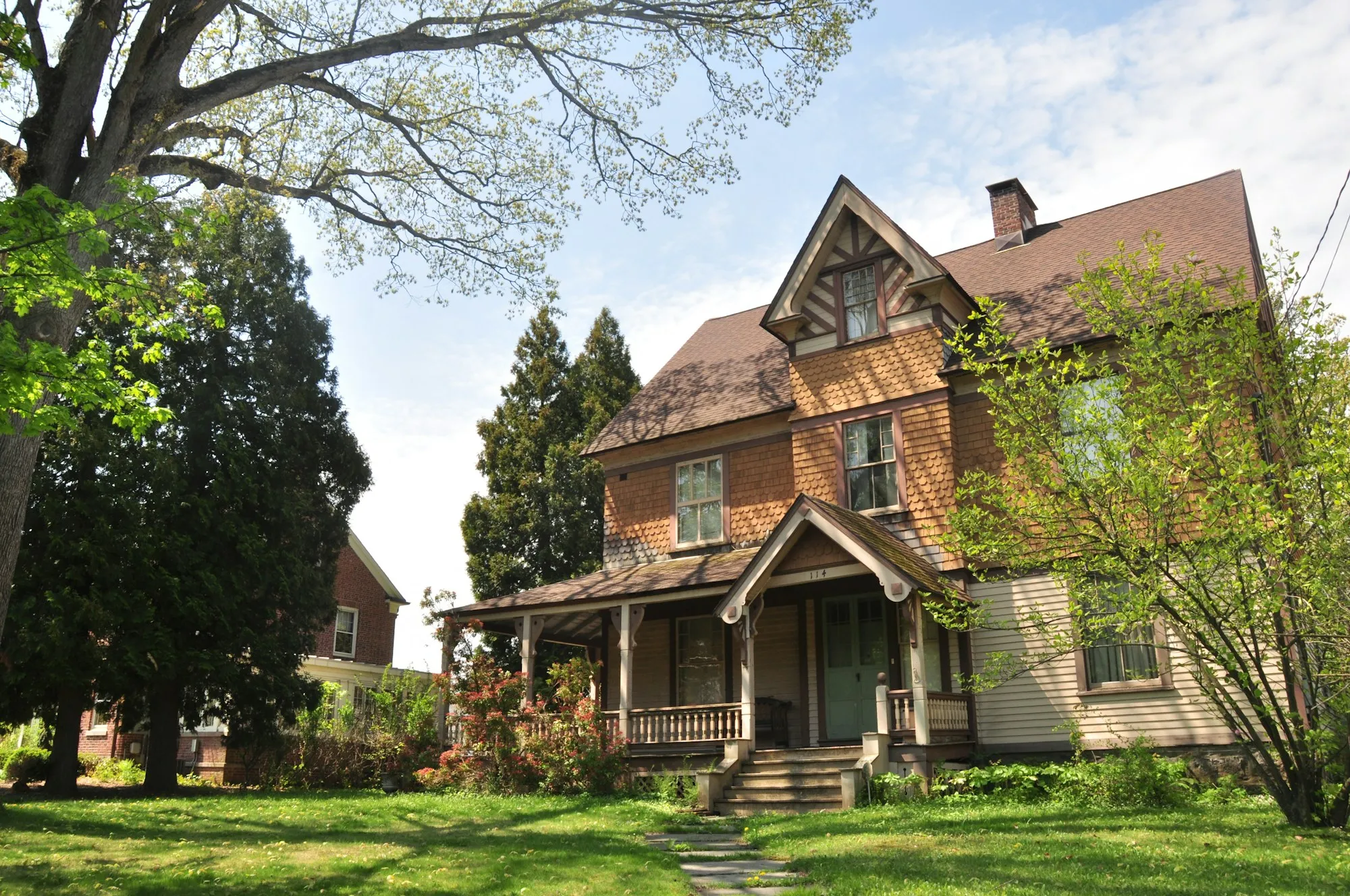 Colonial-style brick home with a large front porch in Maryland