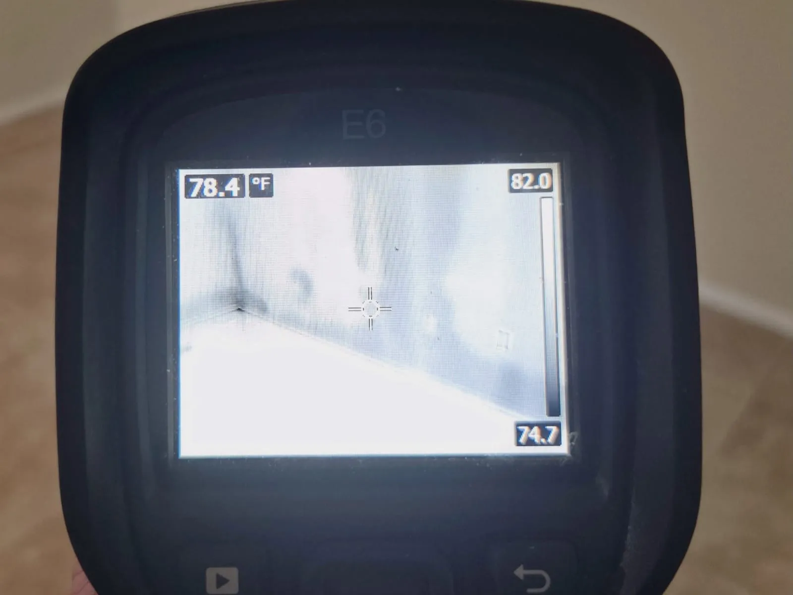 Thermal camera screen showing a cold wet patch on a wall