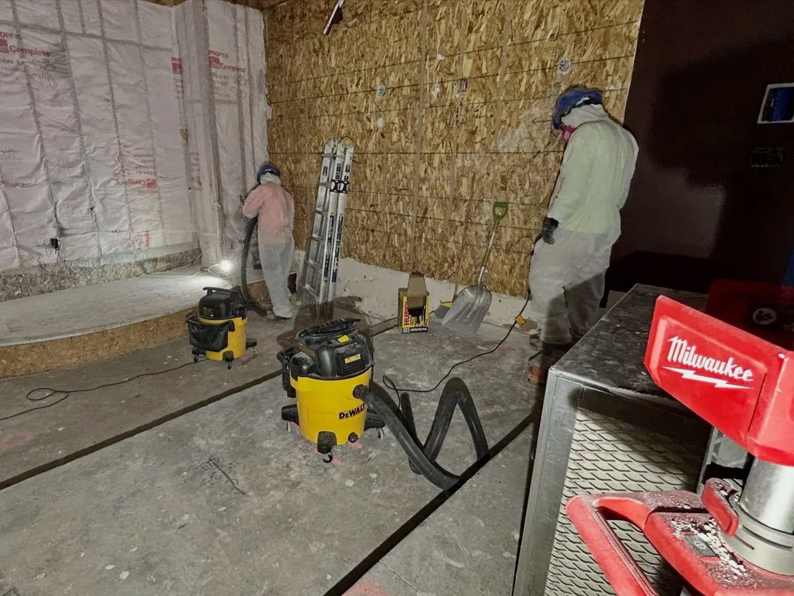 Commercial dehumidifier and air mover running in a basement